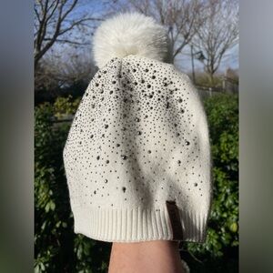 White Beanie with Pom-Pom and studs by Fenely.
NWOT